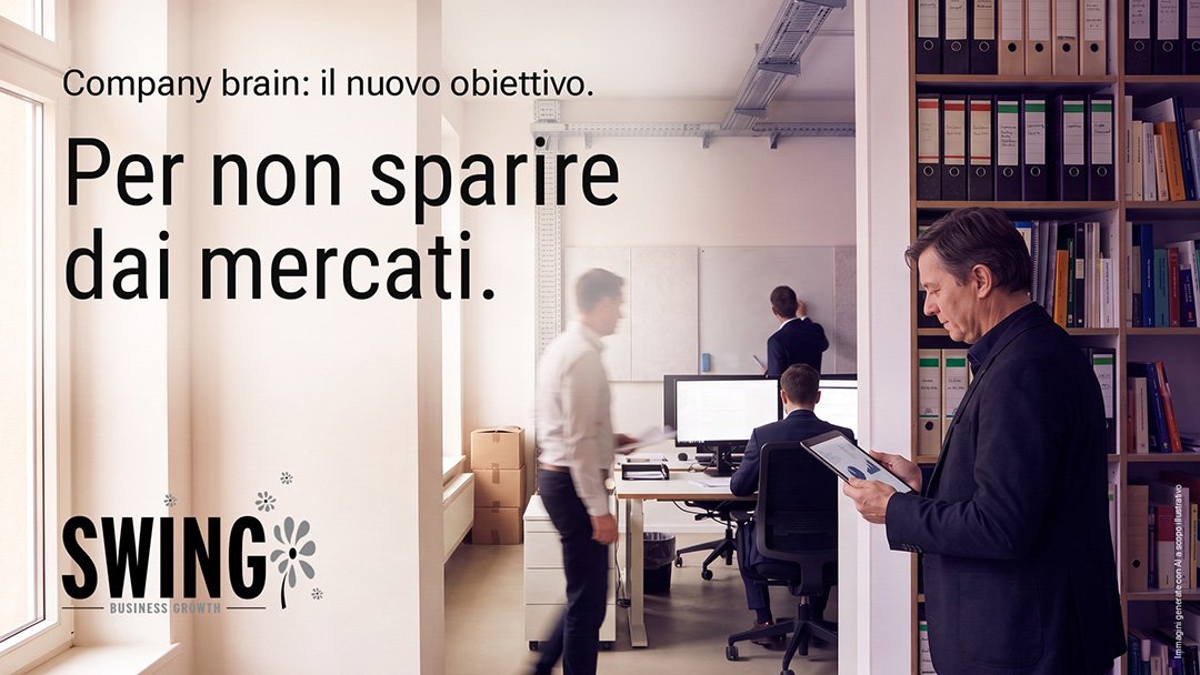 company brain aziendale Company brain aziendale: l’asset che decide chi resta sul mercato. Company brain aziendale: un dirigente legge un grafico sul tablet accanto agli archivi cartacei, mentre l'ufficio lavora alle sue spalle.